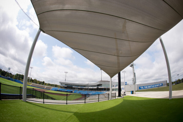 stadium view from beneath large beige sunshade