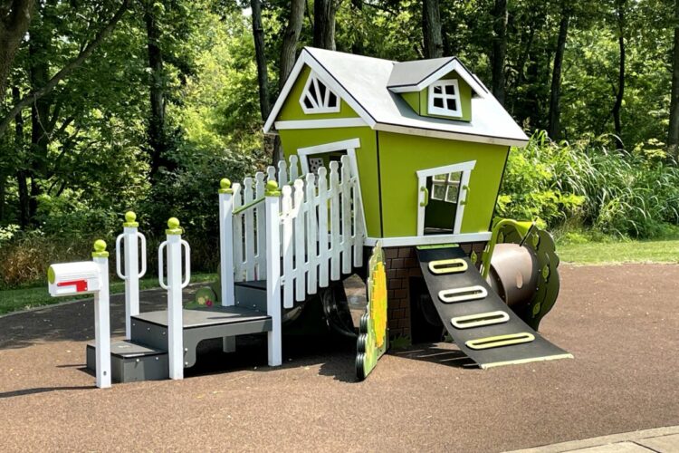 green cottage-shaped playground structure