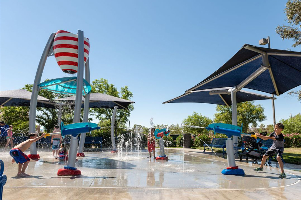 Kids using sprayers at splash pad