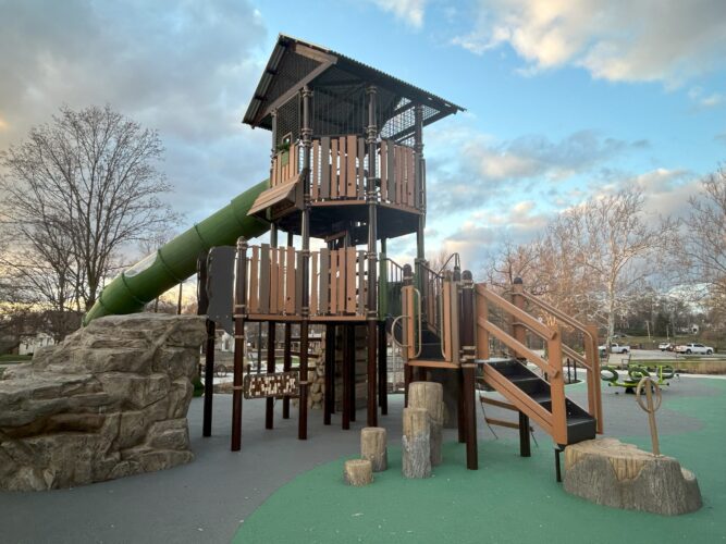 climbing tower shaped like a treehouse with slide at top