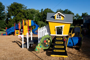 colorful playground tower and playhouse