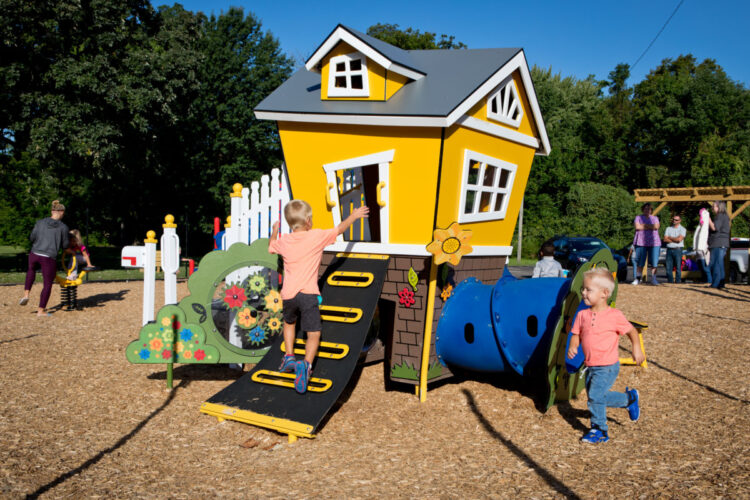 playhouse with tunnel and climbing wall entrance