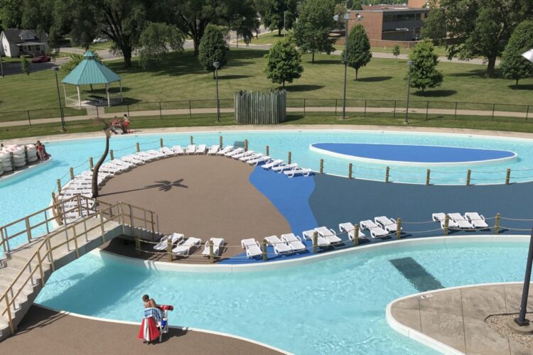 aerial view of the pool and beach surfaces with bridge connecting them all
