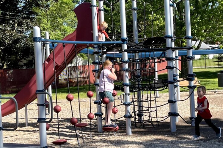 two children playing on climbing ropes