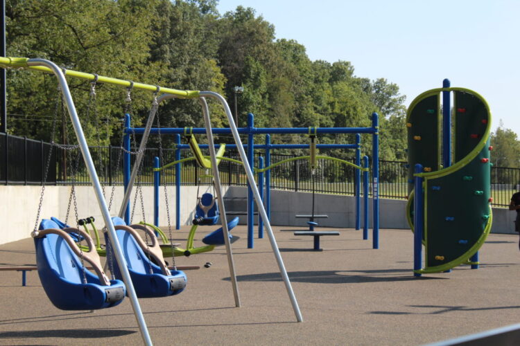row of swings and curved climbing wall