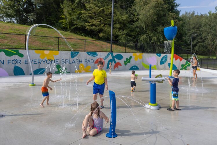girl sitting under a spraying post