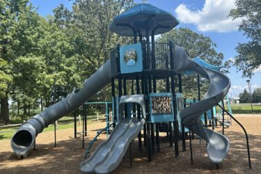 double-decker PlayOdyssey™ Tower featuring a tunnel slide, Whooshwinder™ slide, and a double wave slide