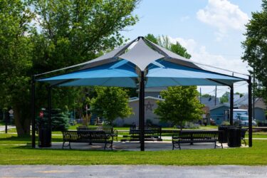 shaded pavilion with benches and picnic tables
