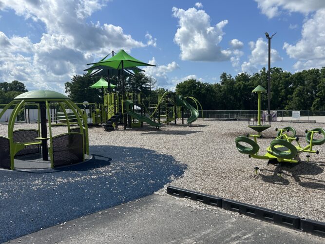wheelchair accessible merry-go-round, wheelchair accessible 4 seater see-saw, spinner, and large play structure