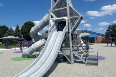 multi-level play structure with double slide and curly tunnel slide