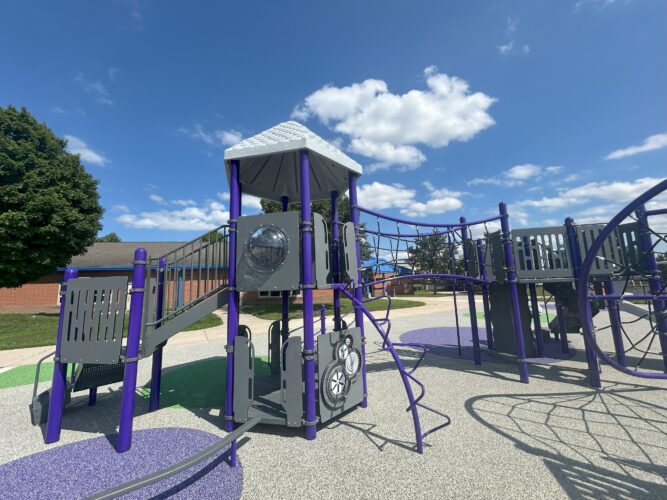 2-story play structure with bridge and balance beam along with a bubble panel and sensory gear panel