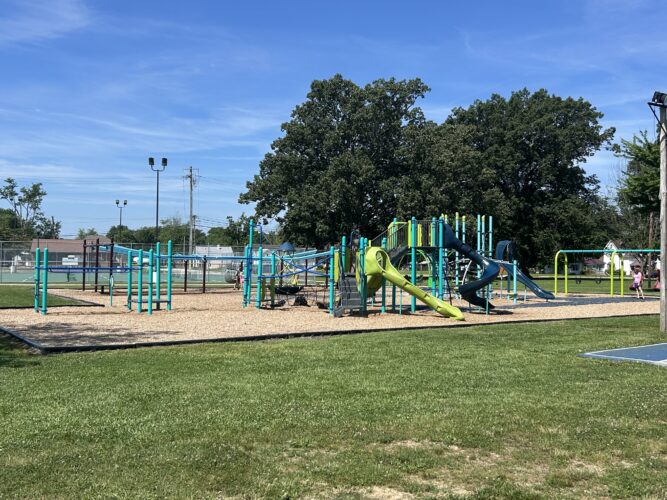 playground for kids aged 5-12 with swings, slides, climbers, and zip line