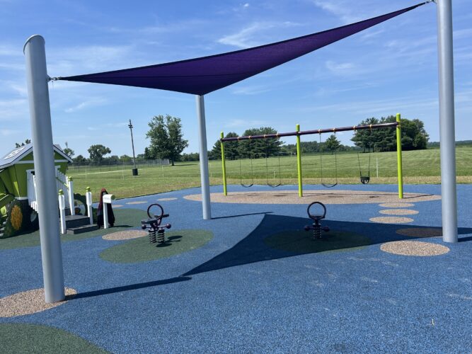 purple triangular fabric shade with a single and double bobble rider