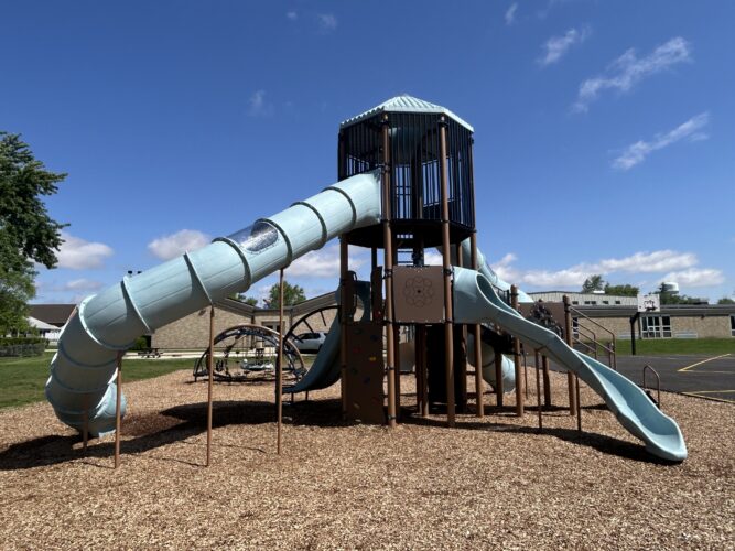 light blue and brown play structures with a tunnel slide and an open, curved slide