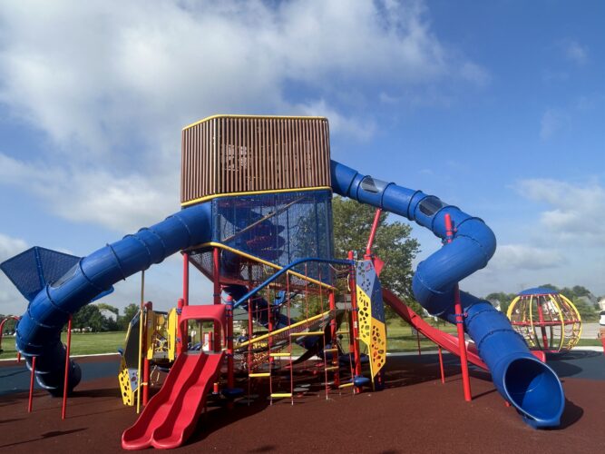 3 level play structure with multiple climbing events and slides