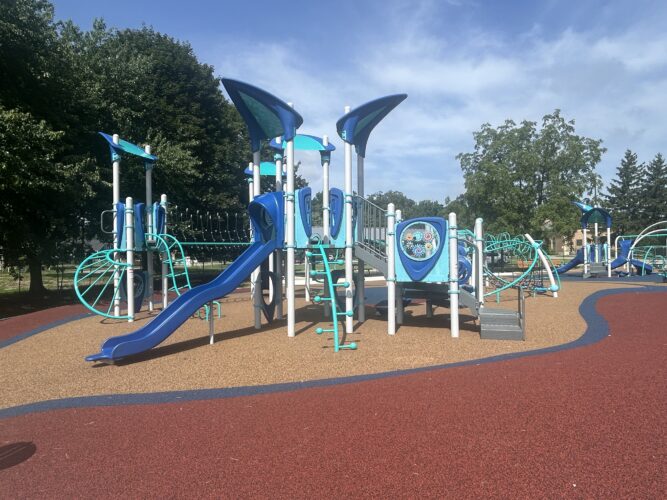 red, blue, and brown rubber safety surfacing with a play structure for 5-12 year old kids