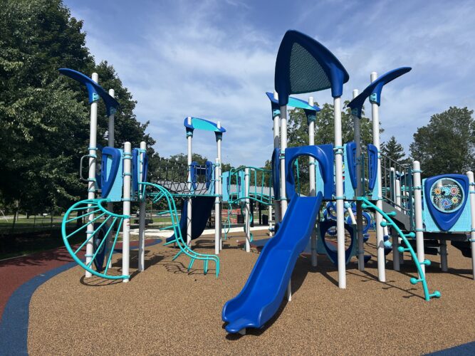 blue, turquois, and gray play structure for kids ages 5-12. blue slide with multiple climbers on rubber surfacing