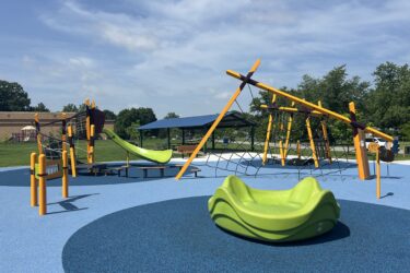 multiple climbing structures, green slide, and zylophone