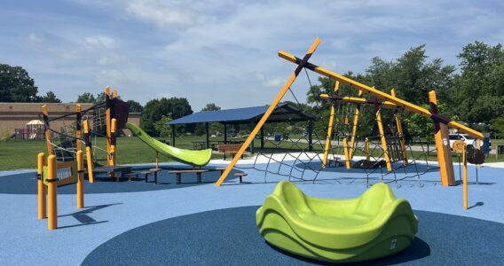 multiple climbing structures, green slide, and zylophone