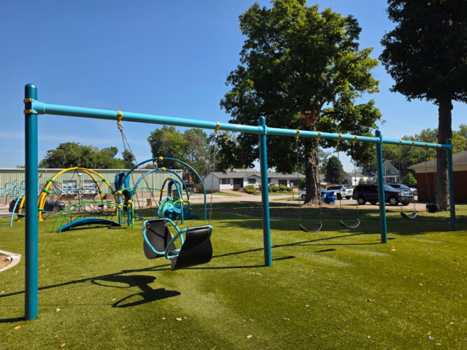 3 bays of swings with 1 baby swing, 3 belt swings, and a 2 person facing each other swing