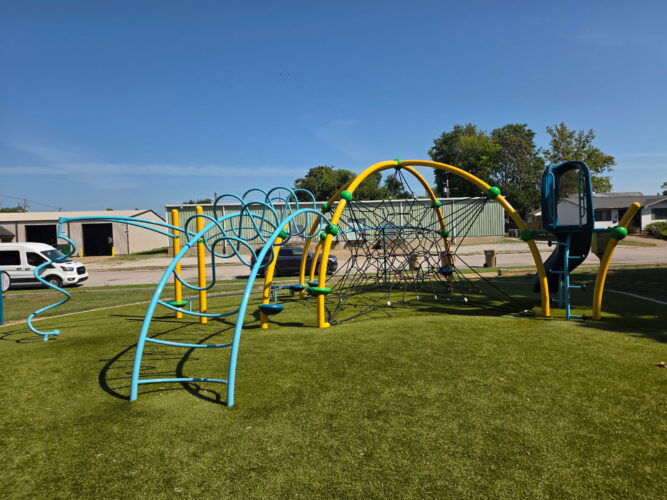 play structure with multiple climbing pieces of equipment