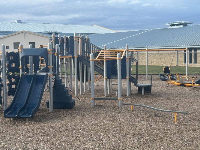 2 blue slides, balance beam, moneky bars, and 4 person seesaw