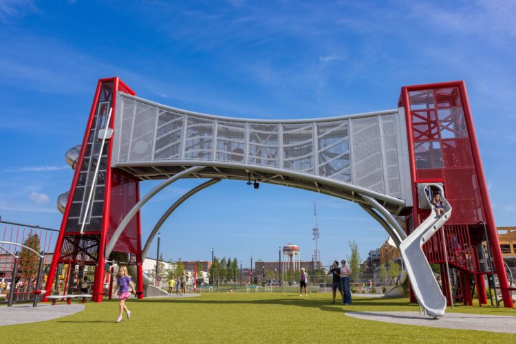 Kids playing on the custom Monon Boulevard playground structure in Carmel, Indiana